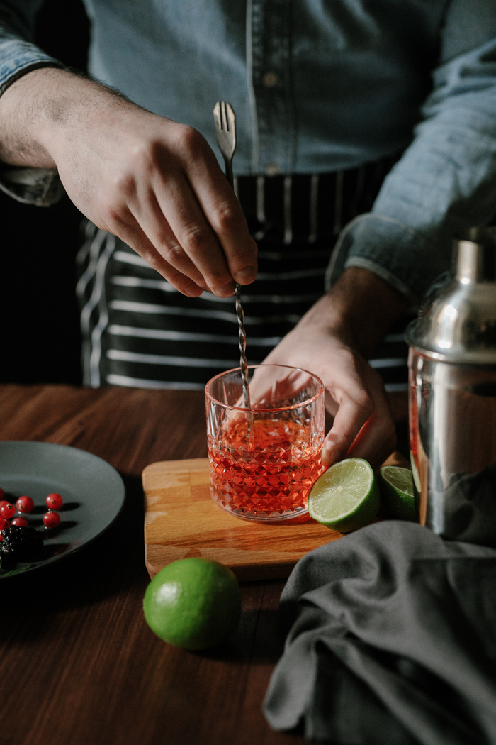 Moody Restaurant Dining and Bartender Mixing a Cocktail